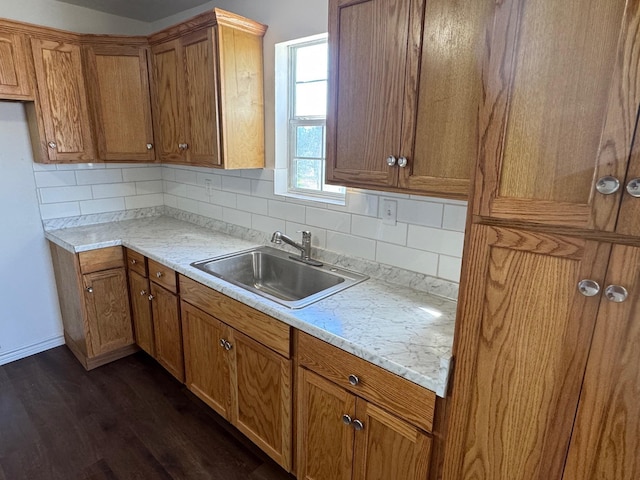 kitchen with backsplash, dark hardwood / wood-style flooring, and sink