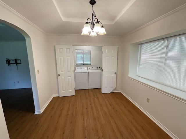 175 Princeton Pl, Vidor, TX 77662 - unfurnished dining area with independent washer and dryer, wood finished floors, arched walkways, a chandelier, and a raised ceiling