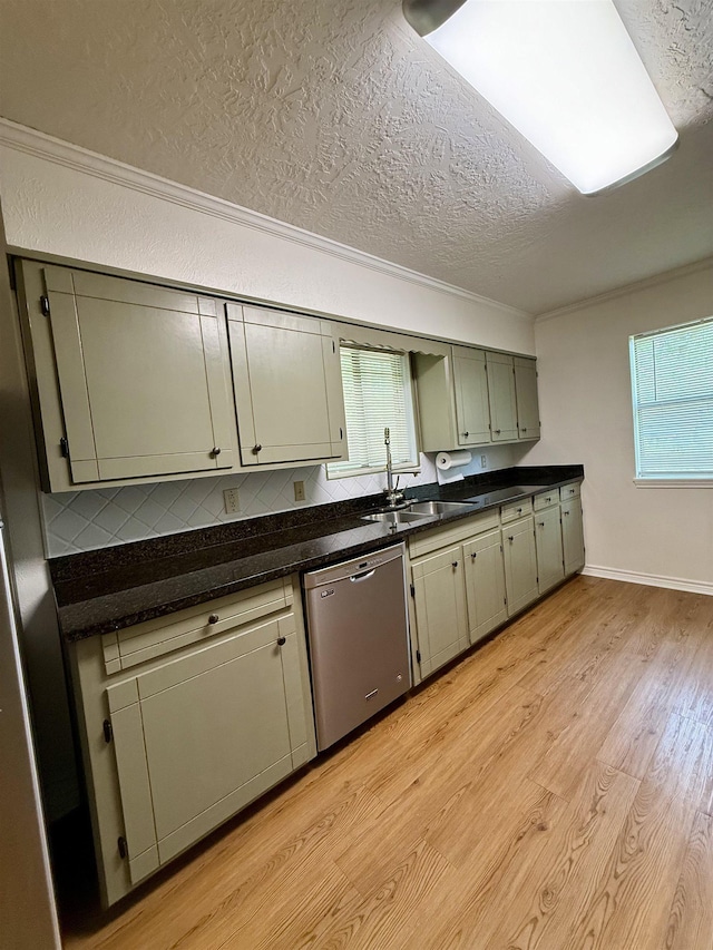 175 Princeton Pl, Vidor, TX 77662 - kitchen featuring stainless steel dishwasher, a sink, a textured ceiling, dark countertops, and plenty of natural light