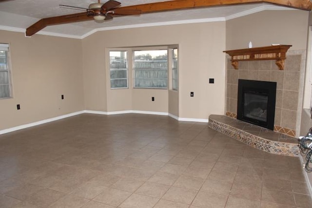 unfurnished living room with lofted ceiling with beams, tile patterned flooring, ceiling fan, ornamental molding, and a tiled fireplace