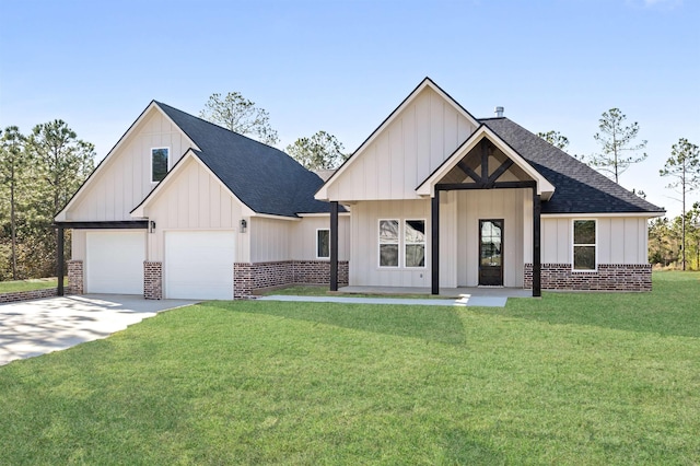 modern farmhouse with driveway, a front lawn, a garage, board and batten siding, and brick siding