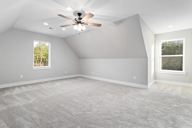 bonus room featuring carpet, visible vents, baseboards, ceiling fan, and vaulted ceiling