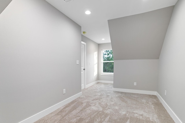 additional living space with recessed lighting, baseboards, lofted ceiling, and carpet flooring