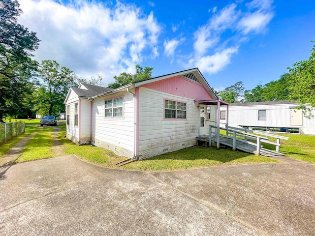 exterior space featuring fence, a yard, and crawl space