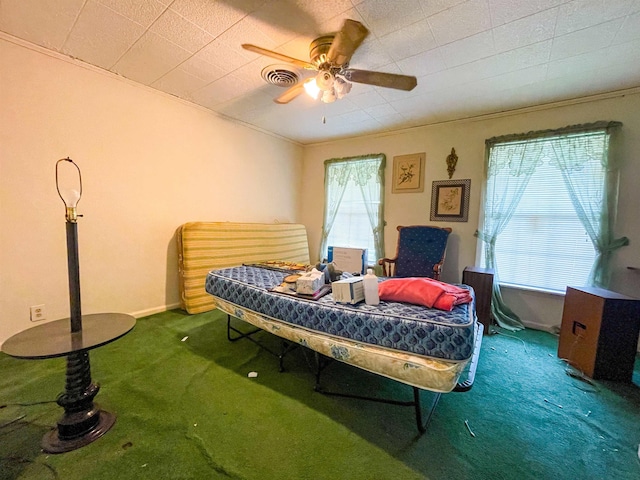 bedroom featuring visible vents, a ceiling fan, and carpet