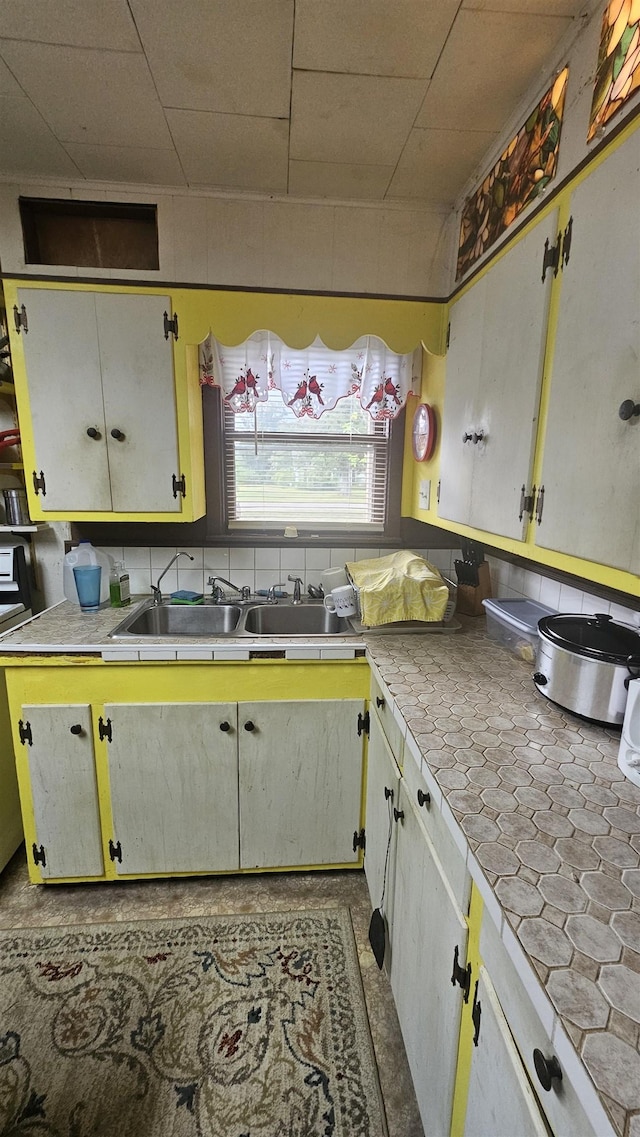 kitchen featuring white cabinets and sink