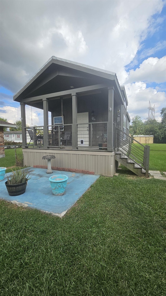 rear view of house featuring a lawn