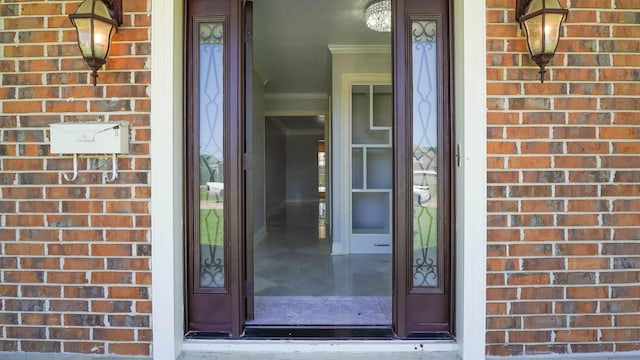 property entrance featuring brick siding