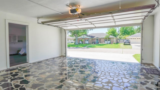 garage with baseboards and a garage door opener