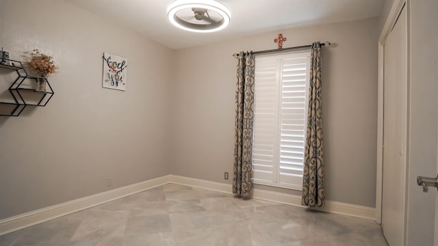 spare room featuring baseboards