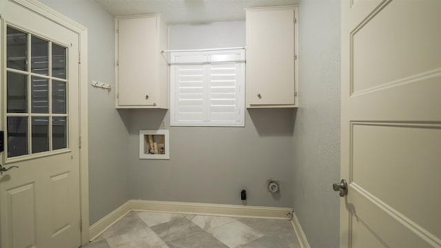 laundry area with cabinet space, baseboards, hookup for a washing machine, and electric dryer hookup