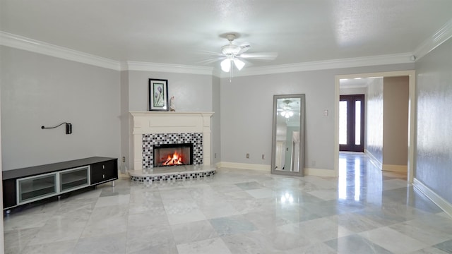 unfurnished living room with ceiling fan, crown molding, baseboards, and a tiled fireplace
