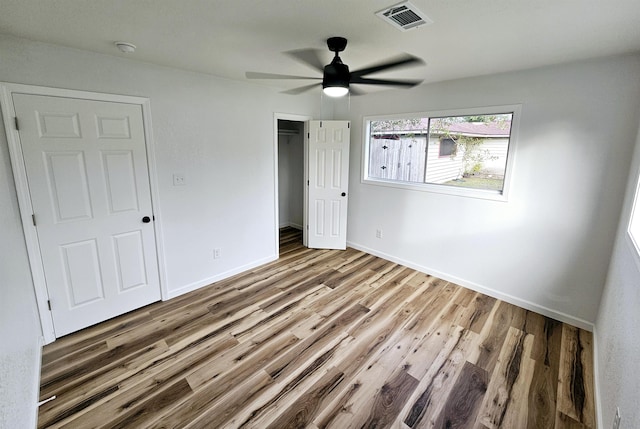 unfurnished bedroom with hardwood / wood-style floors and ceiling fan