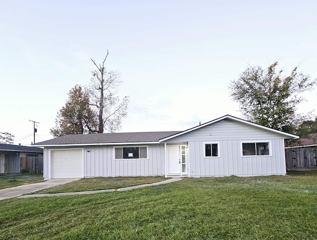 ranch-style house featuring a front yard and a garage