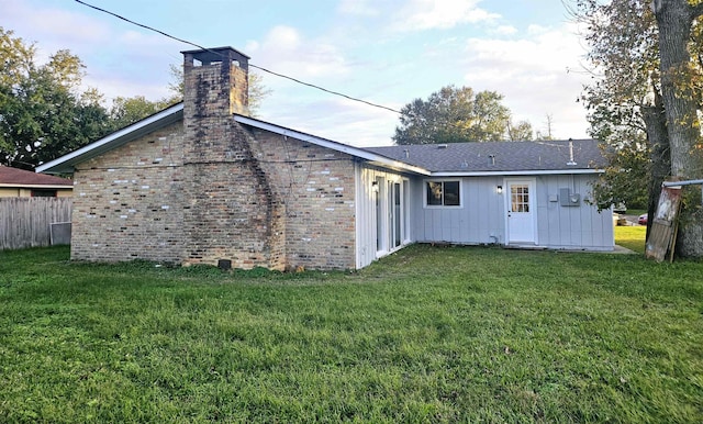 back of property featuring a yard