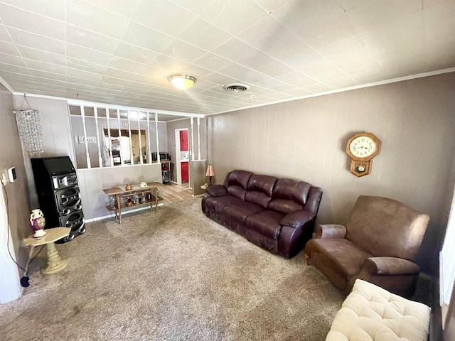 carpeted living room featuring crown molding