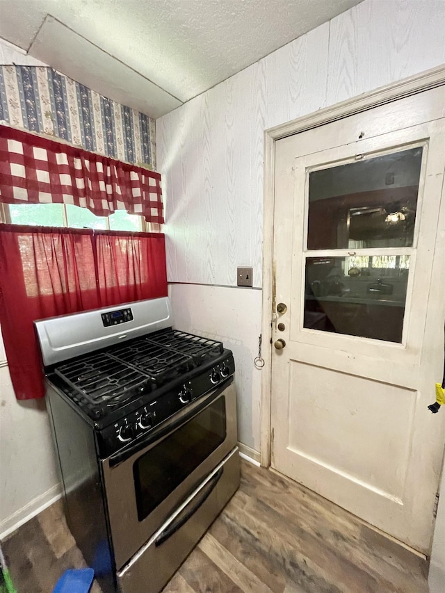 kitchen featuring gas stove and hardwood / wood-style flooring