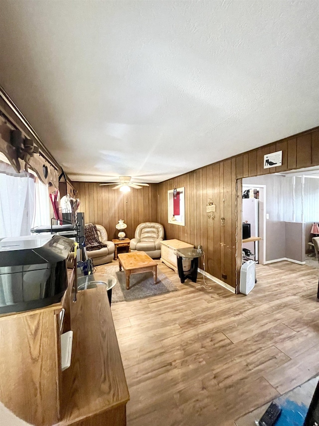 living room featuring a textured ceiling and light hardwood / wood-style flooring