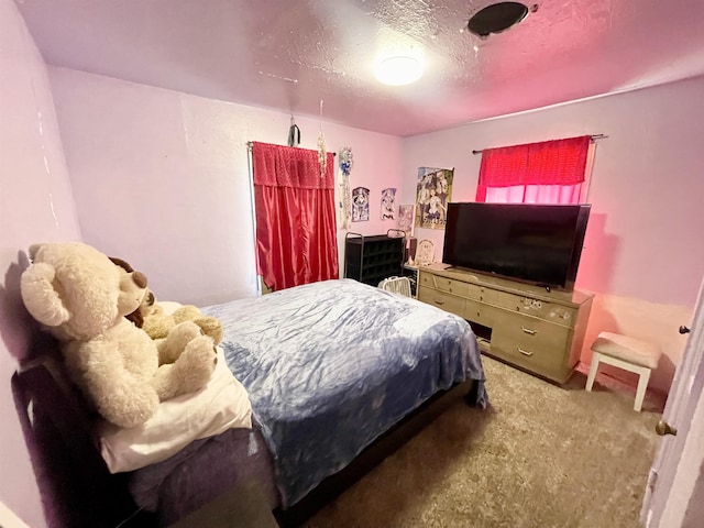 carpeted bedroom with a textured ceiling