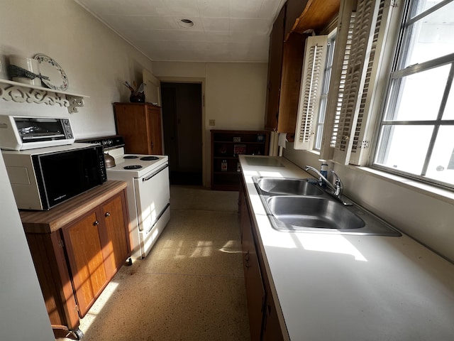 kitchen with black microwave, a toaster, a sink, brown cabinets, and white range with electric cooktop