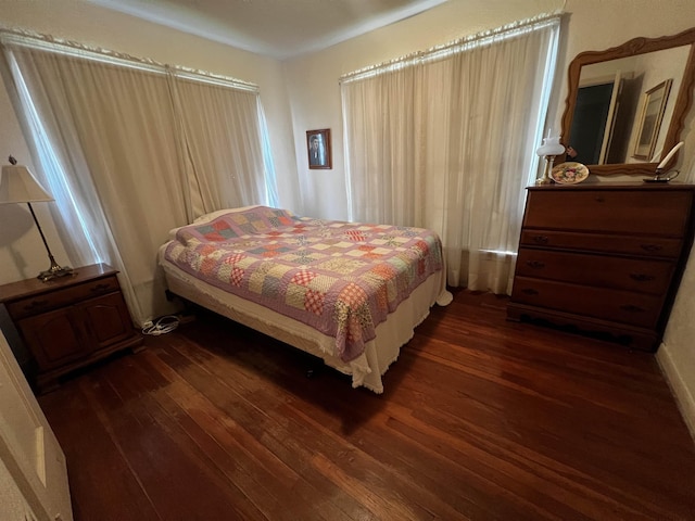 bedroom featuring dark wood-style flooring