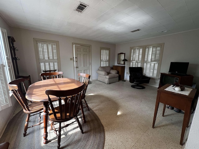 dining room featuring speckled floor and visible vents