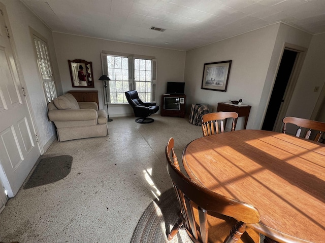 dining room featuring baseboards and visible vents