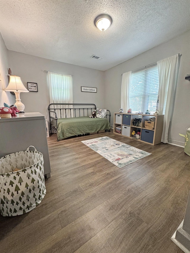 330 Avenue E Ave E, Port Neches, TX 77651 - bedroom featuring a textured ceiling and wood finished floors