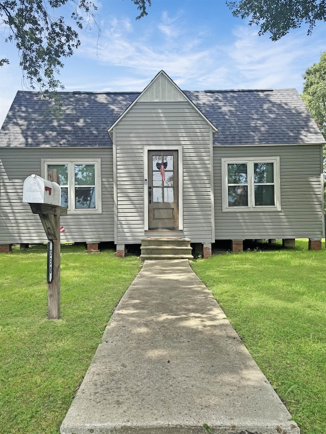 330 Avenue E Ave E, Port Neches, TX 77651 - view of front of house with roof with shingles, a front lawn, and entry steps