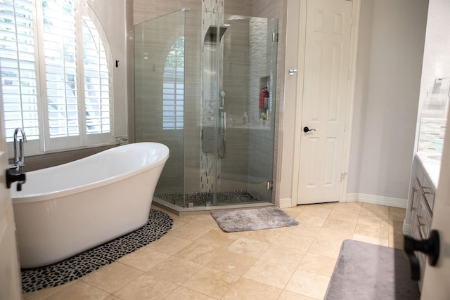 5065 Oakmont Dr, Beaumont, TX 77706 - bathroom featuring a freestanding tub, a stall shower, vanity, and tile patterned floors