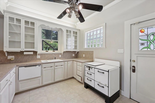 507 Orange Ave, Orange, TX 77630 - kitchen featuring crown molding, decorative backsplash, dishwasher, light countertops, and a ceiling fan