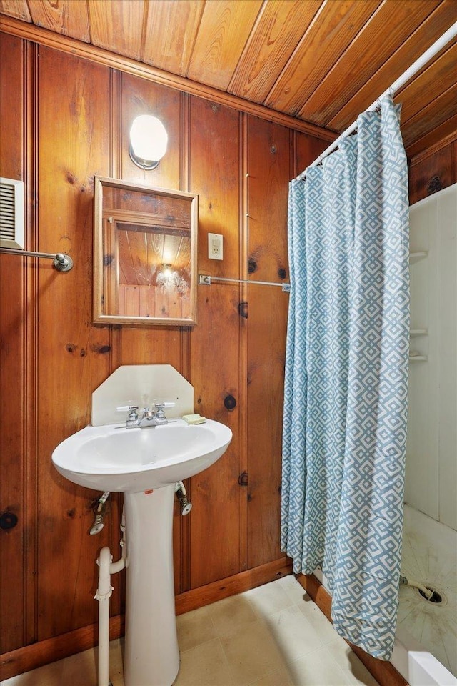 507 Orange Ave, Orange, TX 77630 - bathroom with a shower with shower curtain, wooden ceiling, and wooden walls