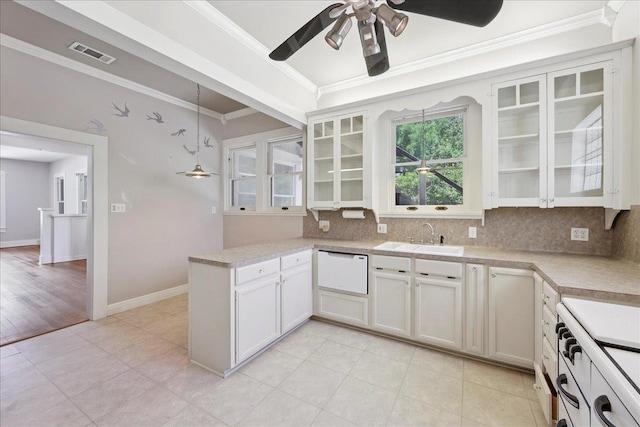 507 Orange Ave, Orange, TX 77630 - kitchen with crown molding, ceiling fan, decorative backsplash, white appliances, and light countertops