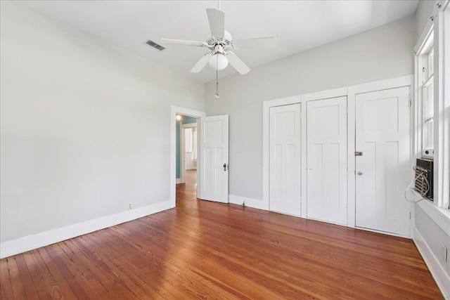 507 Orange Ave, Orange, TX 77630 - unfurnished bedroom with wood finished floors and a ceiling fan