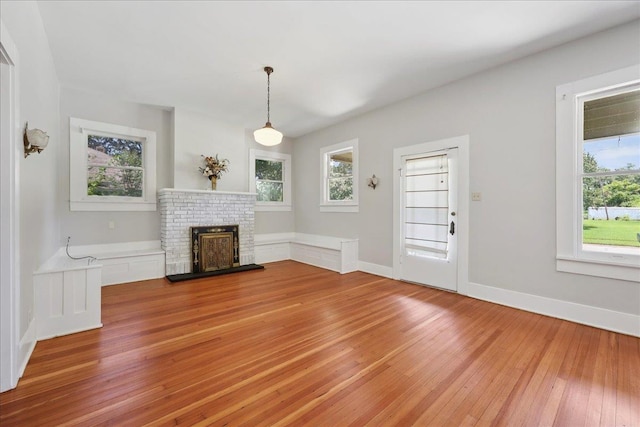 507 Orange Ave, Orange, TX 77630 - unfurnished living room featuring light wood-style flooring and a brick fireplace