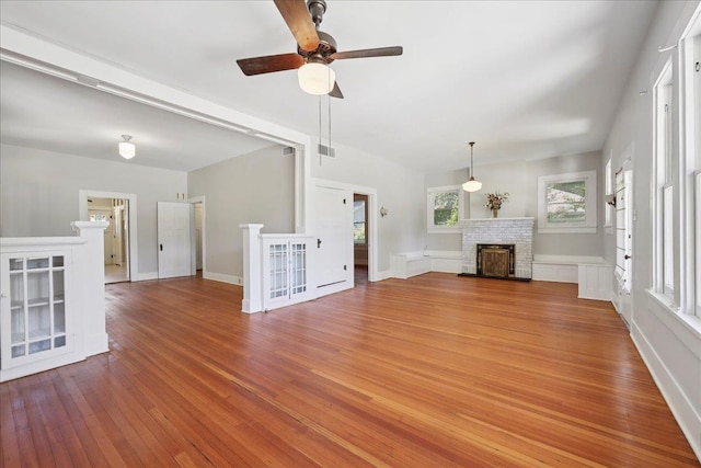 507 Orange Ave, Orange, TX 77630 - unfurnished living room featuring light wood-type flooring, ceiling fan, and a fireplace
