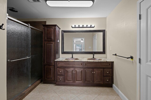 1503 18th St, Nederland, TX 77627 - bathroom featuring a shower stall, double vanity, tile patterned flooring, and baseboards