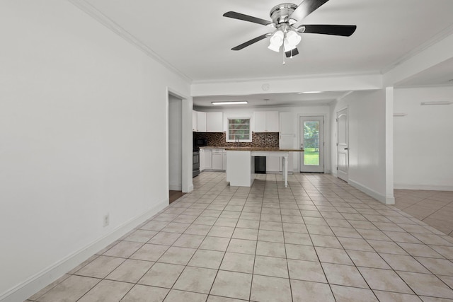 1503 18th St, Nederland, TX 77627 - unfurnished living room featuring crown molding, ceiling fan, light tile patterned floors, and baseboards