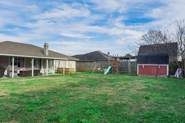 view of yard featuring a storage shed, an outdoor hangout area, and a playground