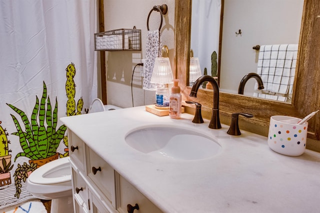 bathroom featuring vanity and toilet