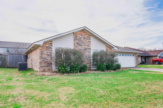 ranch-style home featuring central AC, a garage, and a front yard