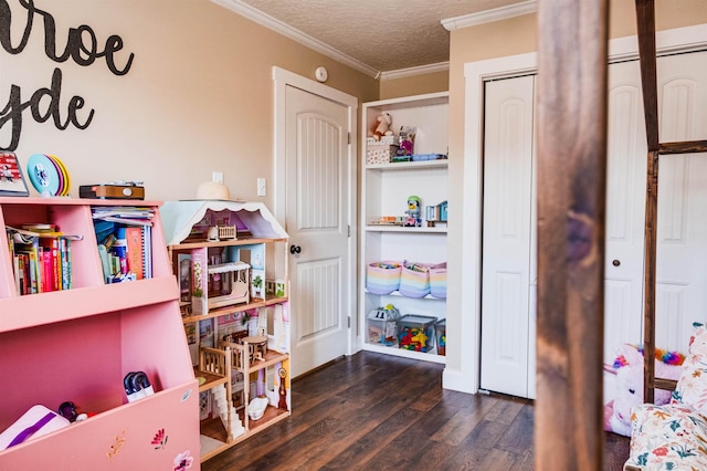 game room featuring dark hardwood / wood-style flooring, crown molding, and a textured ceiling