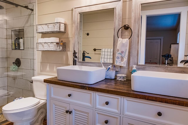 bathroom with vanity, toilet, and walk in shower