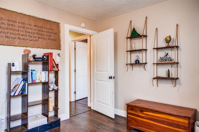 corridor featuring dark hardwood / wood-style floors and a textured ceiling