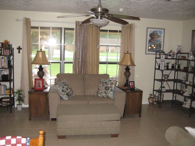 tiled living room featuring a textured ceiling and ceiling fan