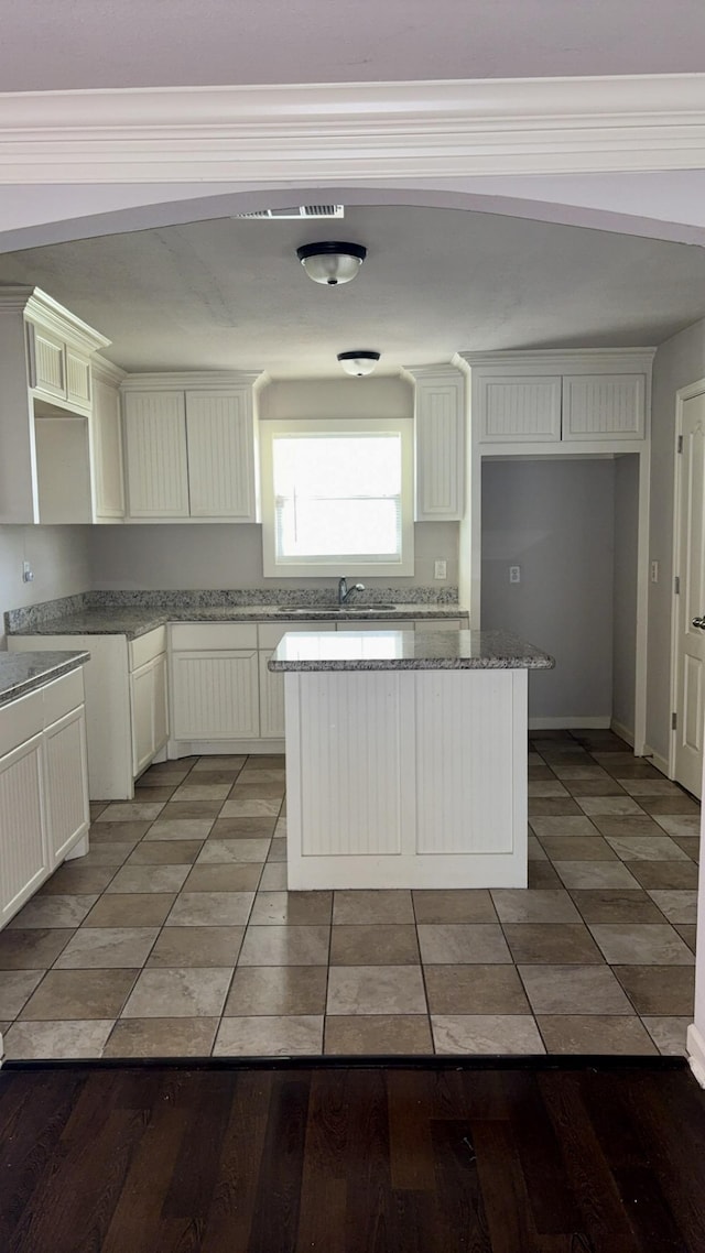 5440 Margo Ln, Beaumont, TX 77708 - kitchen featuring a kitchen island, light wood-style floors, and stone countertops