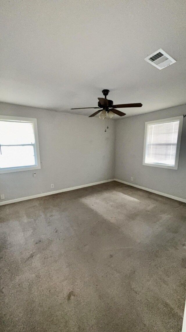 5440 Margo Ln, Beaumont, TX 77708 - carpeted empty room with a ceiling fan, a textured ceiling, baseboards, and visible vents