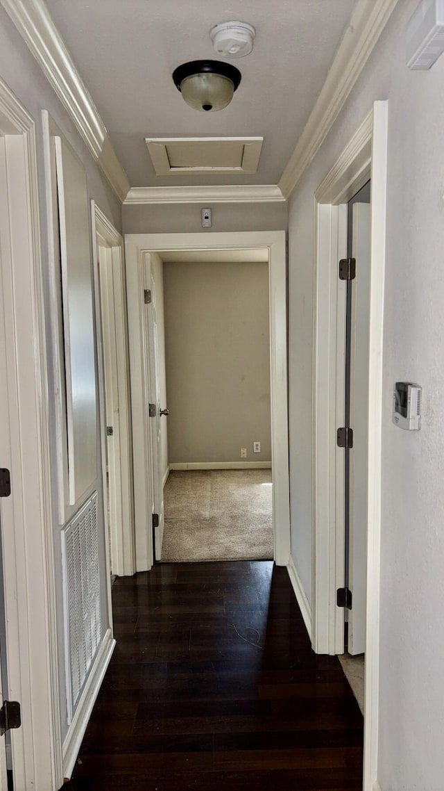5440 Margo Ln, Beaumont, TX 77708 - hall with dark wood-style flooring, visible vents, baseboards, ornamental molding, and attic access