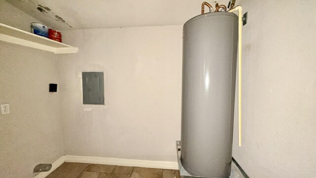 5440 Margo Ln, Beaumont, TX 77708 - clothes washing area with electric panel, baseboards, and gas water heater