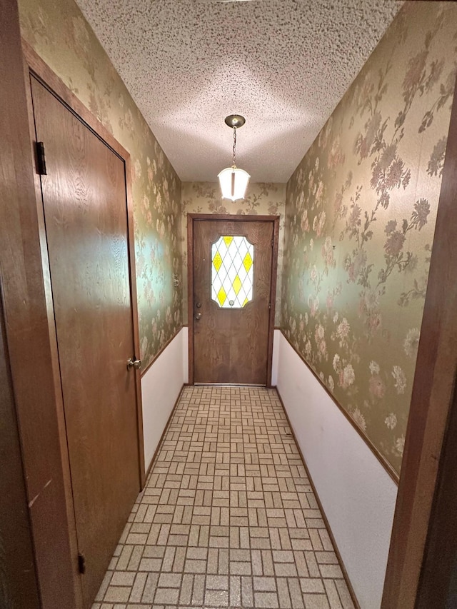 entryway with a textured ceiling